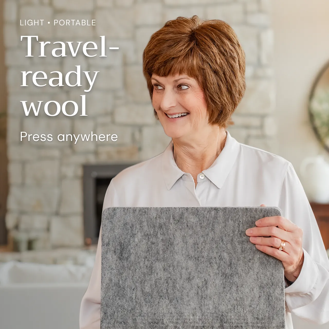 A woman holds the compact gray Novodon pressing mat in a bright home interior.